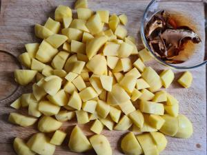 würfelig geschnittene Kartoffeln und eingeweichte Steinpilze für Kartoffelsuppe Rezept