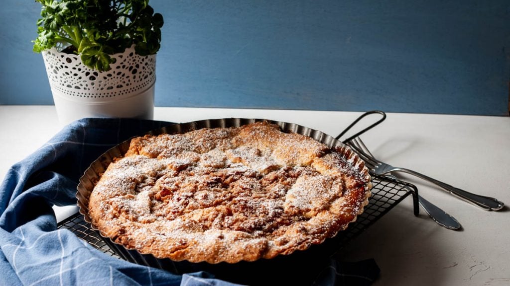 Ein Apfelkuchen steht auf einem Auskühlgitter