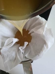 Flüssigkeit wird in Sieb mit Passiertuch gegossen