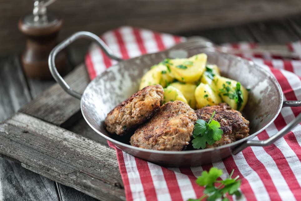 Buletten mit Kartoffeln in Pfanne