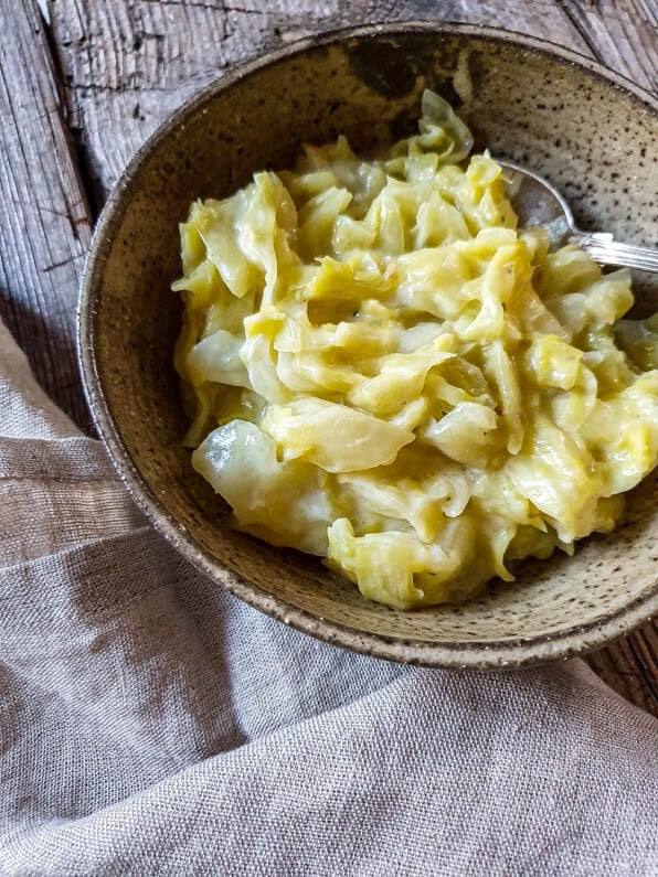 Eine Bowl mit Spitzkohl steht auf einer Holzplatte.