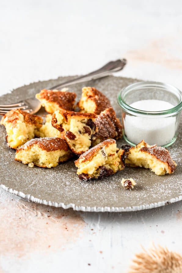 Ein Teller mit Kaiserschmarrn und Zucker auf hellem Untergrund