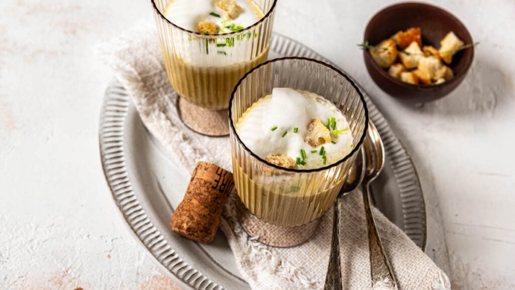 In Gläser angerichtete Prosecco-Schaumsüppchen auf Tablett mit Croutons