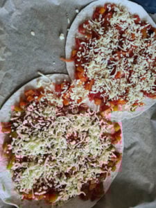 zwei überlappende Pizzen auf Backblech
