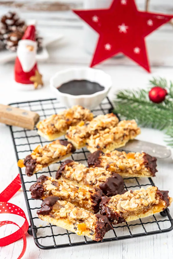 Saftige Florentiner Schnitten auf Gitter, dekoriert mit Tannenzweig und Winterdeko